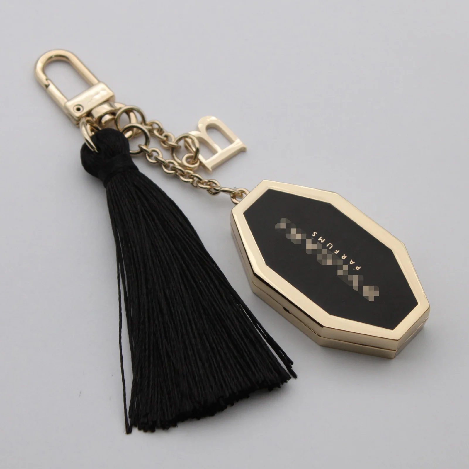 Hexagon locket keyring shown with its letter charm