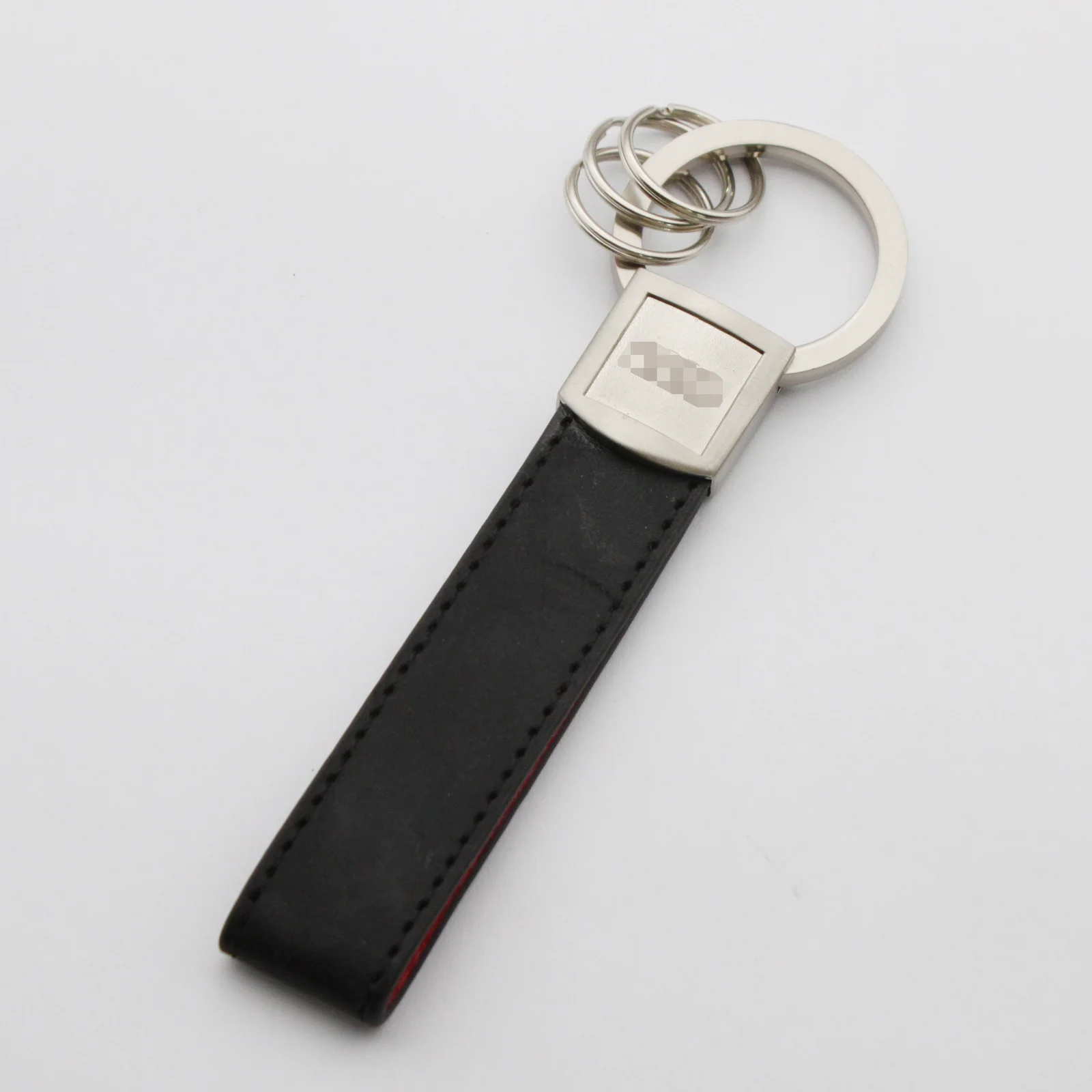 Reverse of the leather key fob showing the embossed logo