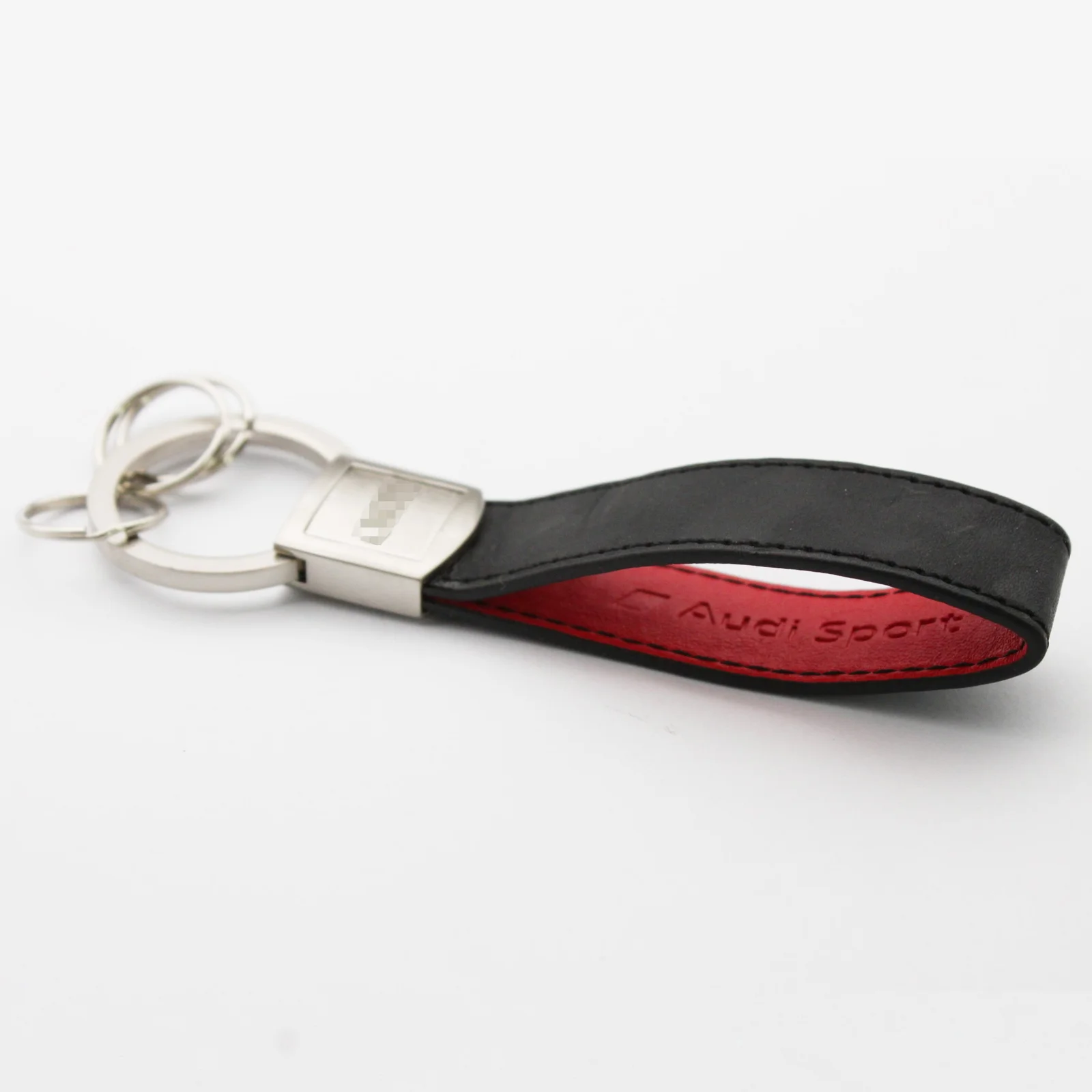 Leather key fob shown with its rotating metal head
