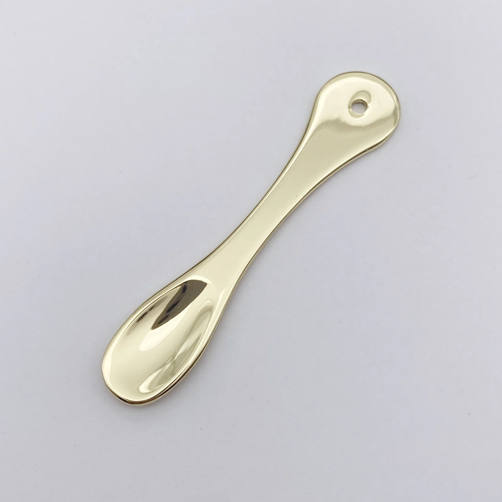 Close view of the polished gold finish on the spatula