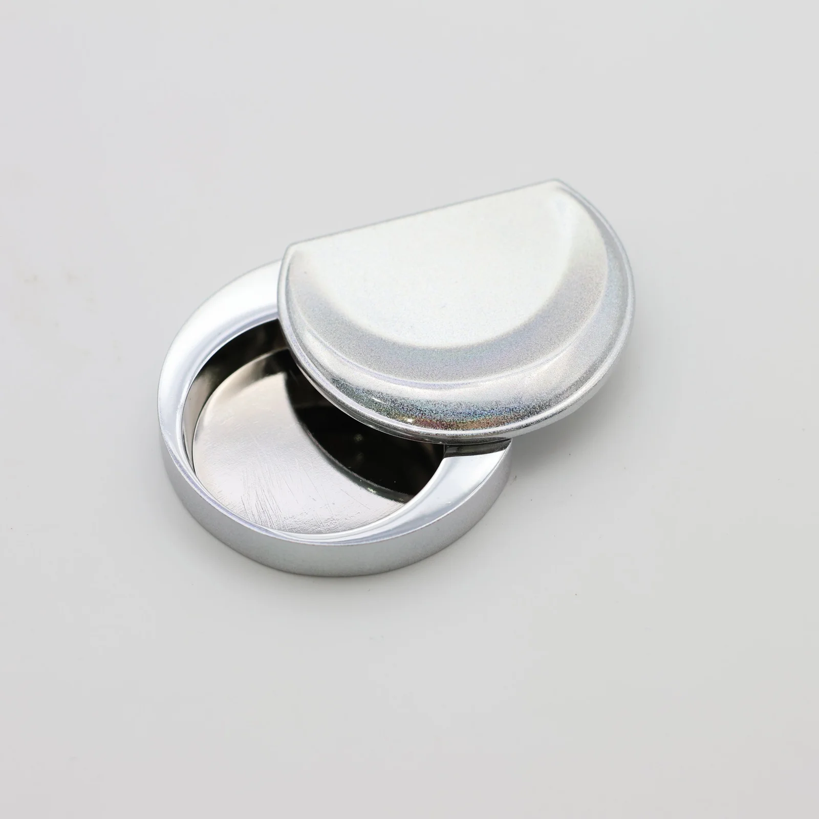 Moon shaped perfume case shown closed
