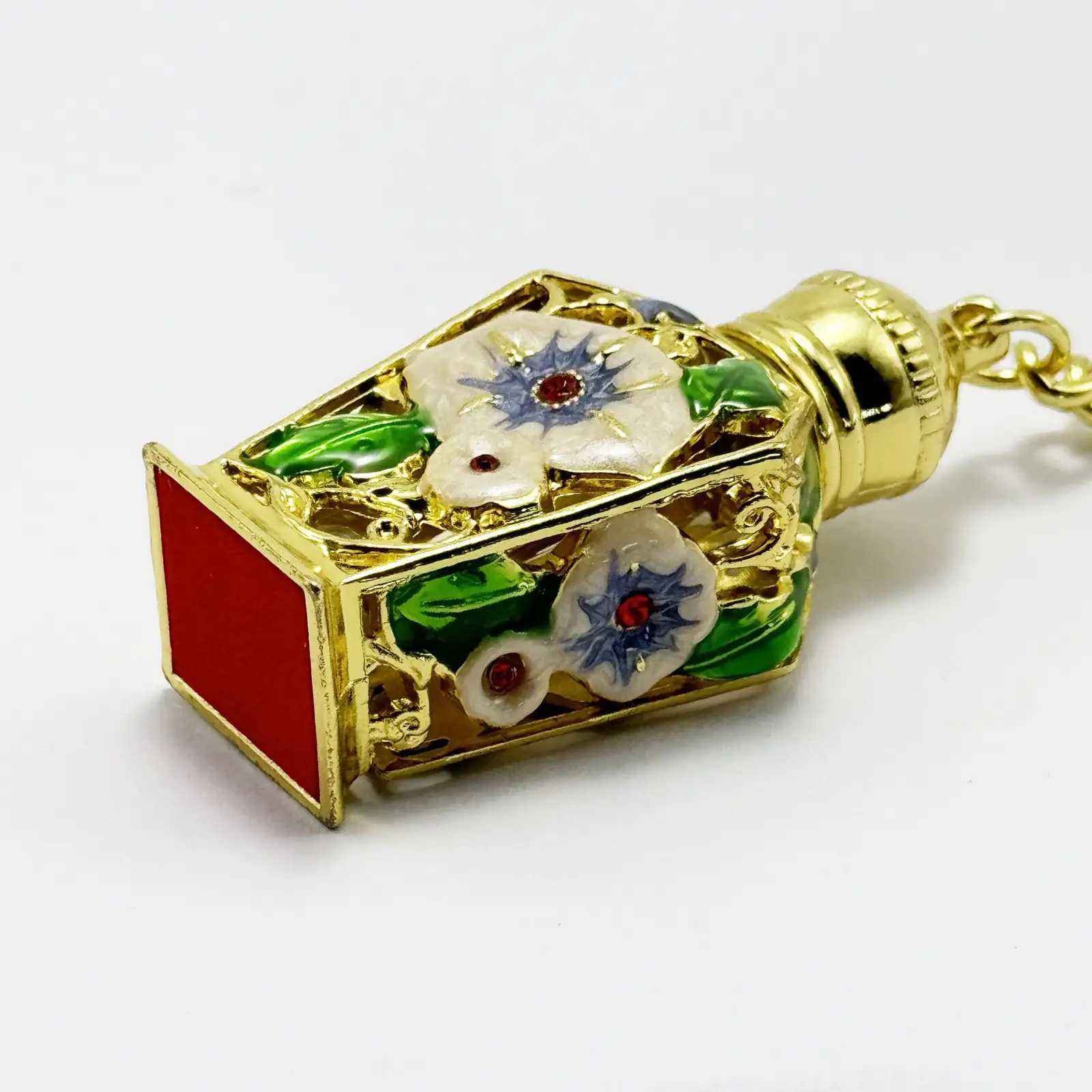 Perfume bottle keyring shown with the cap removed