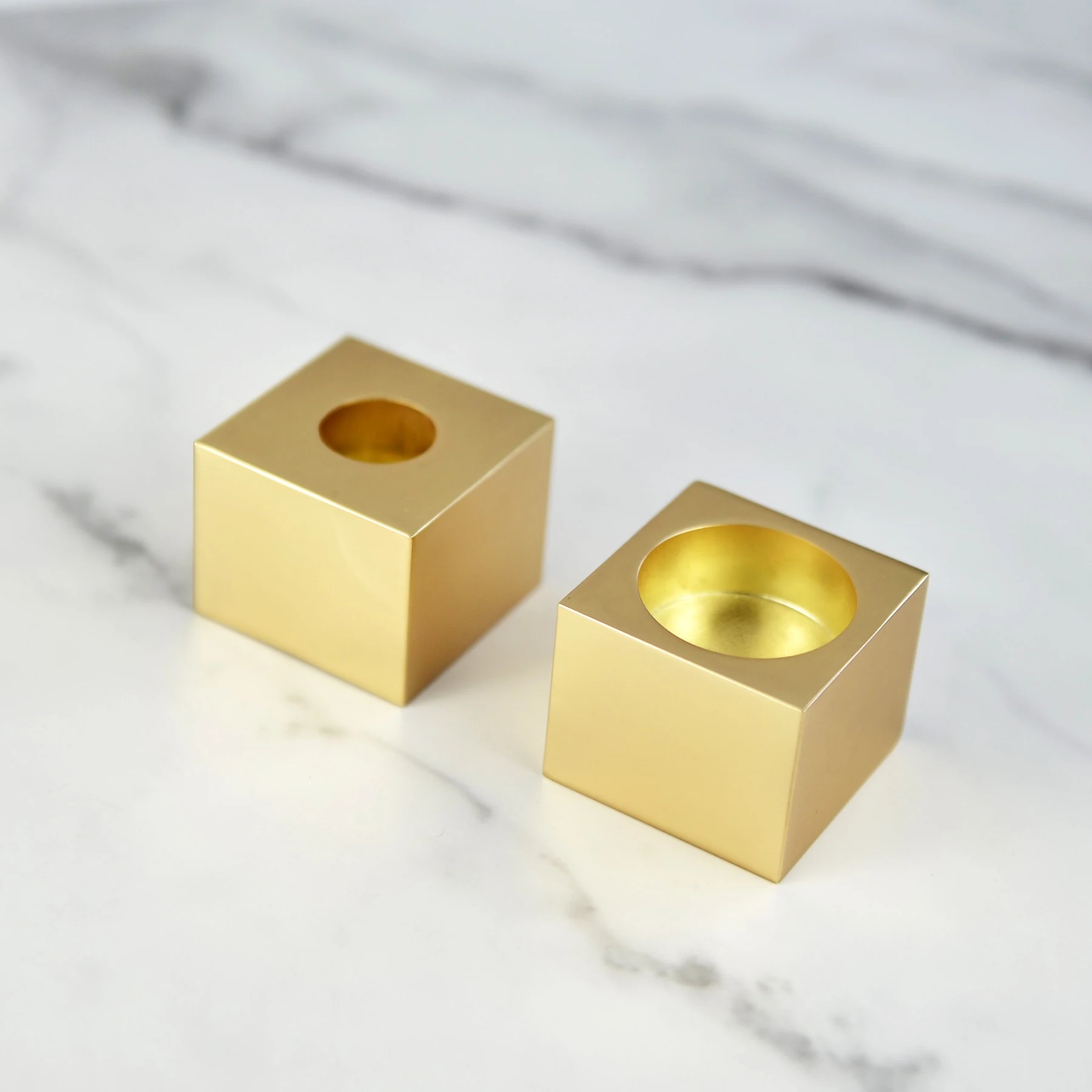 Modern cube Shabbat candlesticks shown side by side