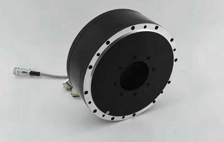Black torque motor with silver mounting flange and hollow shaft centre