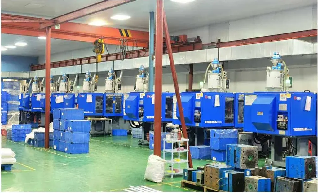 Injection moulding hall. Frame and lens blanks are moulded here rather than bought in, which is what lets us c