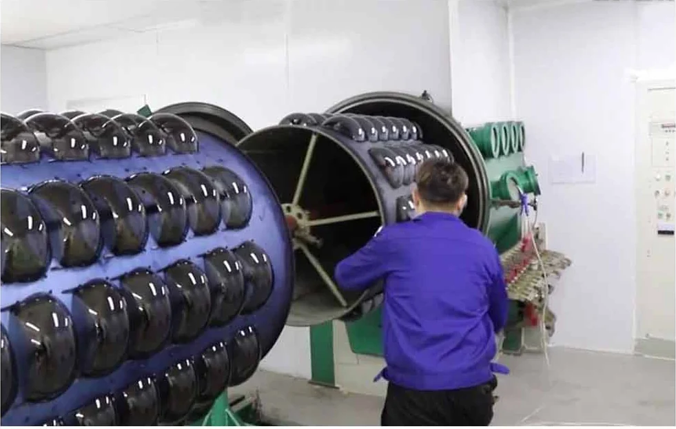 Vacuum coating chamber loaded with lenses. Mirror and hard coatings run in our own line, so a repeat order can
